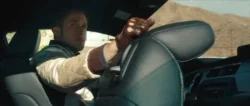 Driver waiting outside for a robbery with closeup on his brown driving gloves